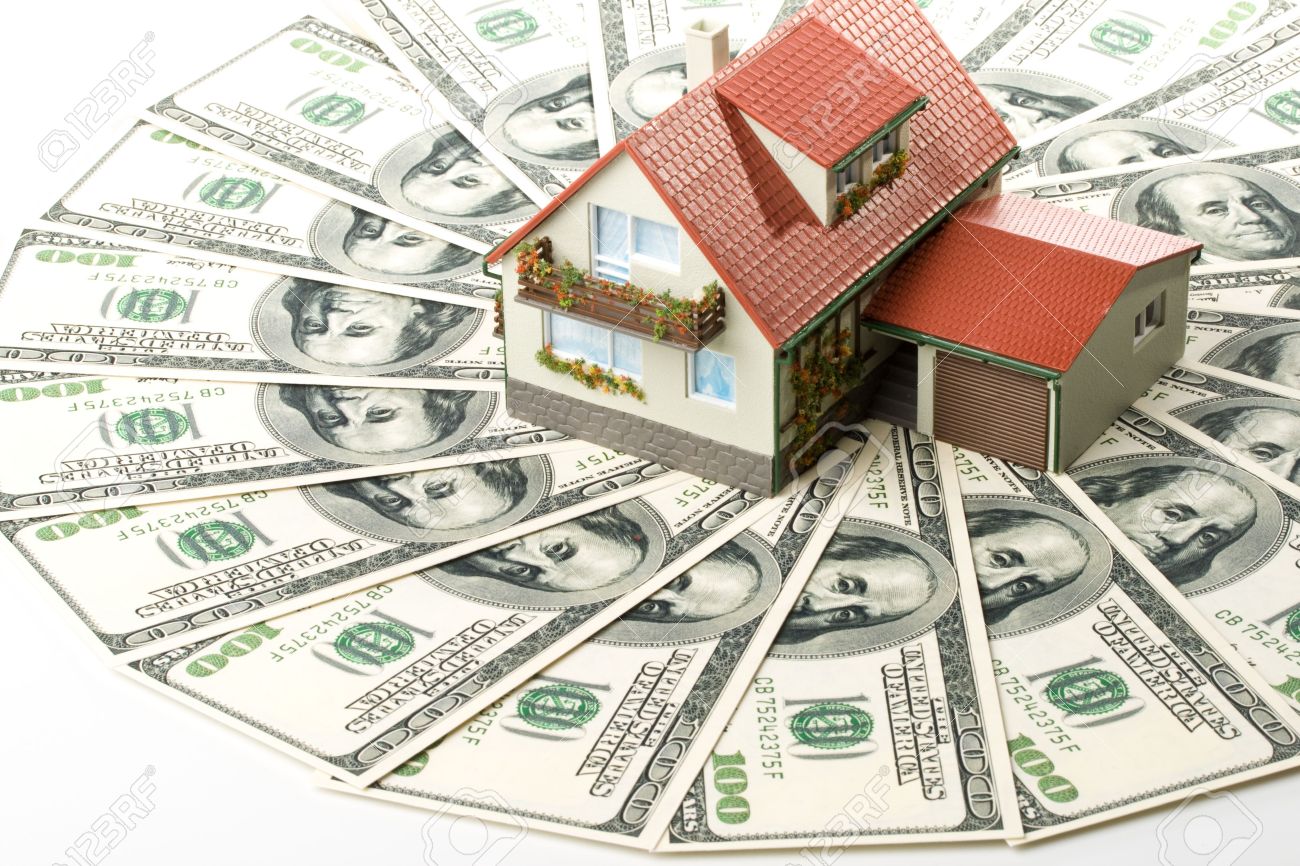 3360761-Miniature-House-and-Money-Buying-house-concept-Stock-Photo